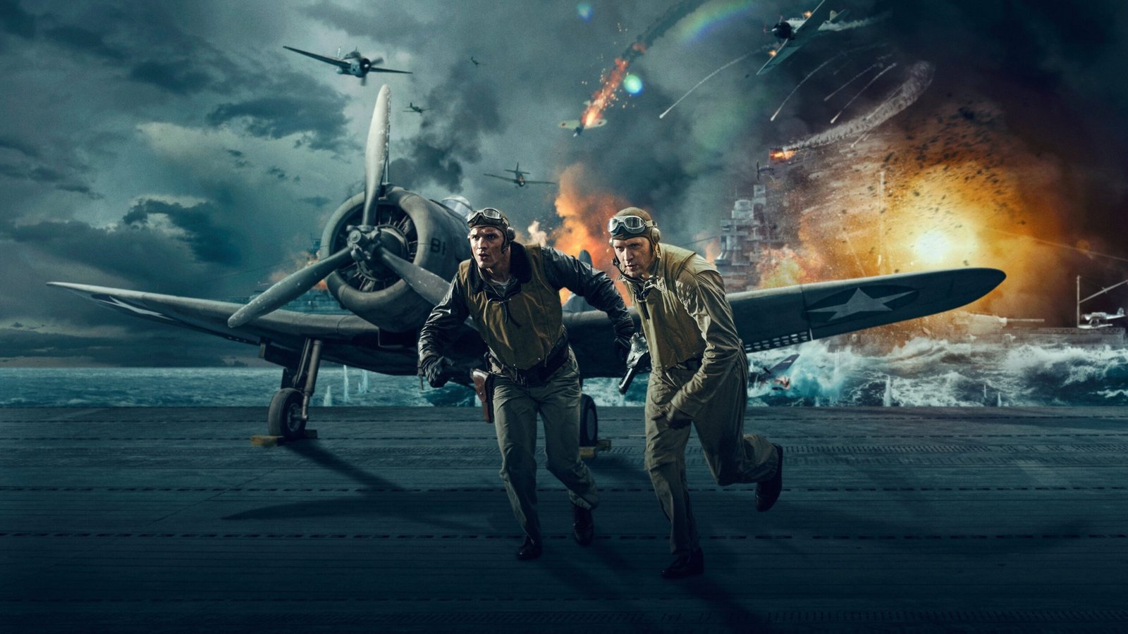 Two WWII-era airmen sprint across a carrier deck as explosions and burning ships fill the background behind them.