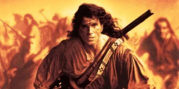 John Rambo-style action hero runs forward with a rifle strapped across his chest, amid a blazing, orange-tinted battlefield background.